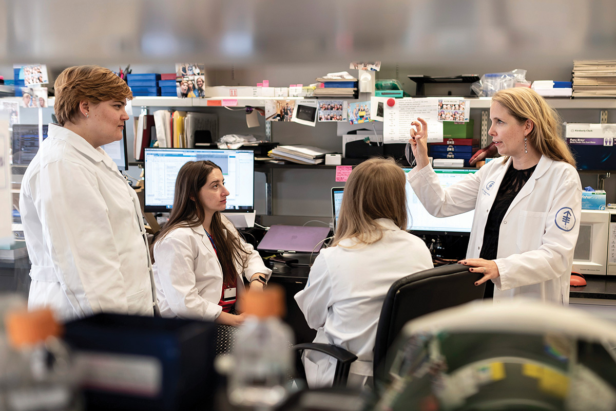 A group of scientists meet in a lab