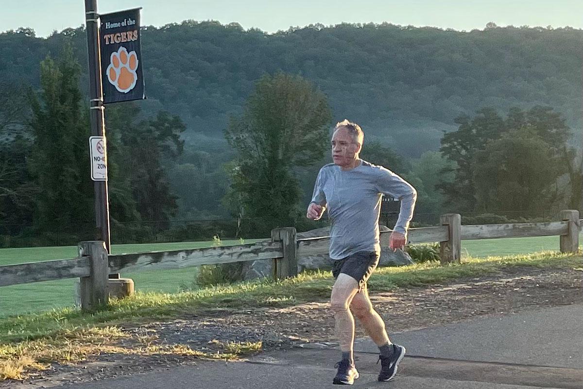 A man running along the side of a road